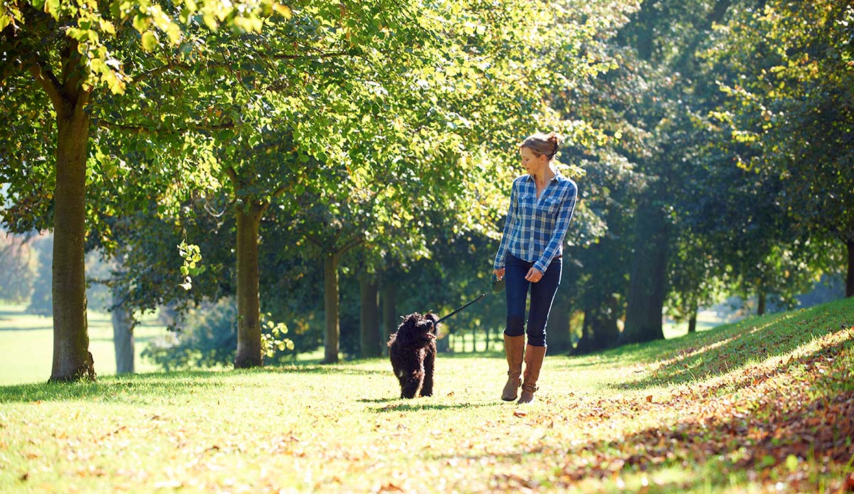 Woman walking outdoors with dog