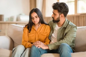 Young couple having a serious conversation at home.