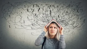 Confused looking woman covering her head with a book while black scribble graphics are overhead