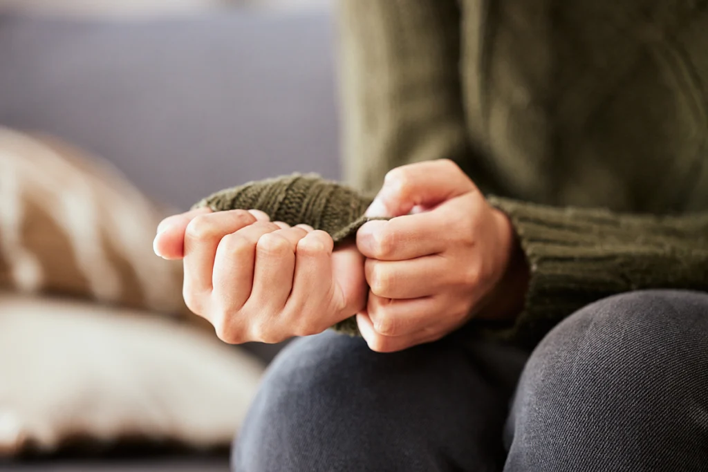 Woman fidgeting with her sleeve out of anxiety