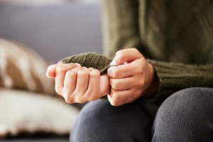 Woman fidgeting with her sleeve out of anxiety